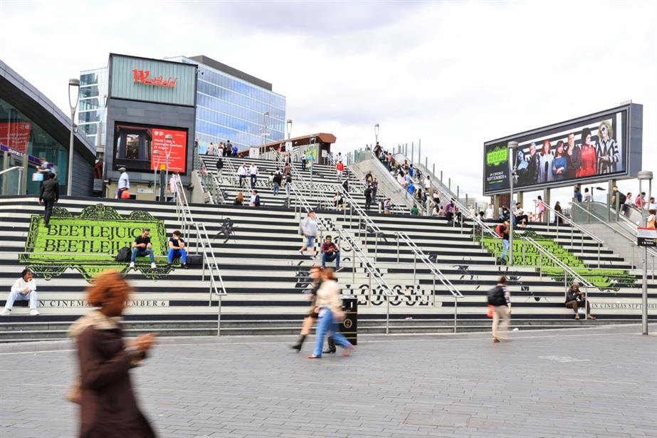 A wide shot of the creative on the Meridian Steps at Westfield Stratfield City