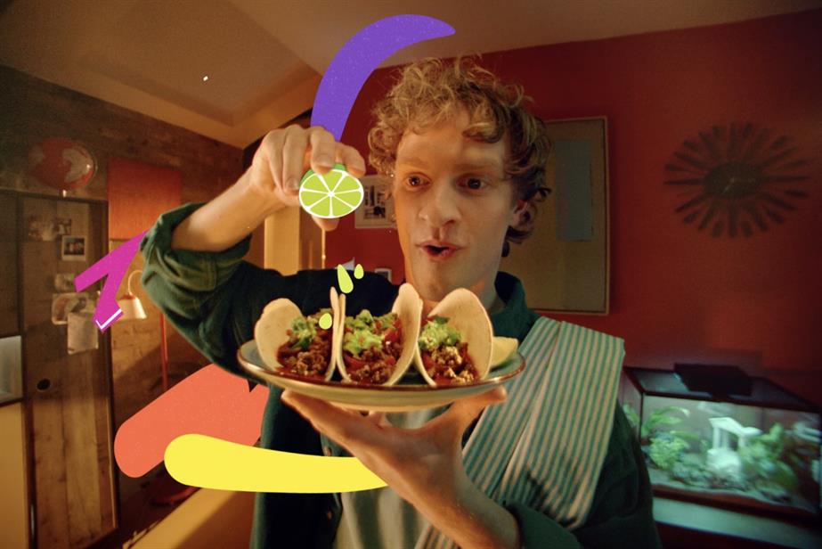 Man squeezing a cartoon lime over tacos 