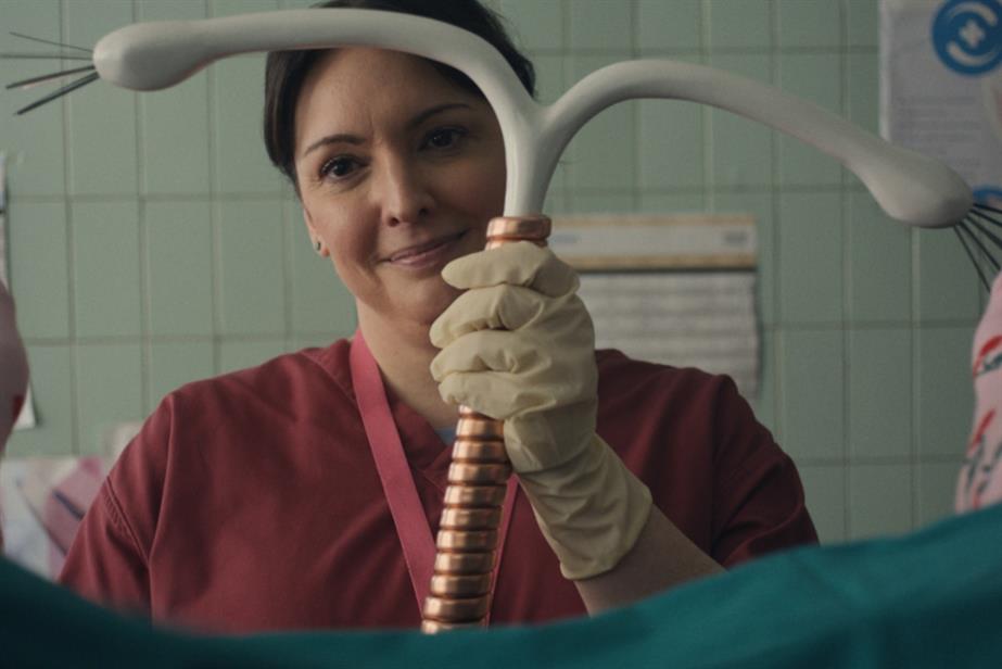 Bodyform ad woman holding giant IUD