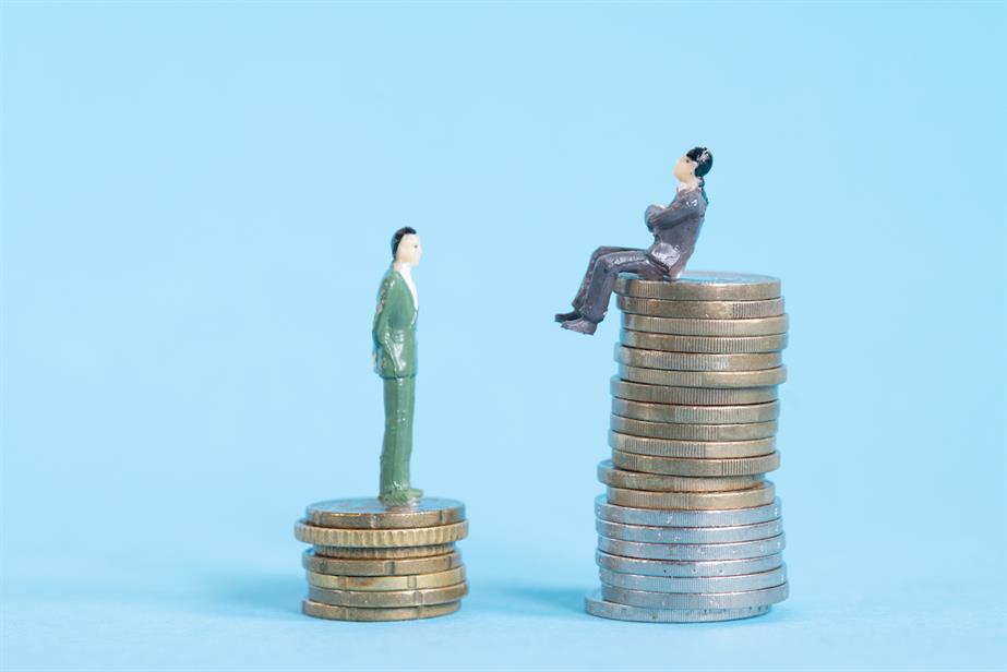 Two figurines sat on pile of coins