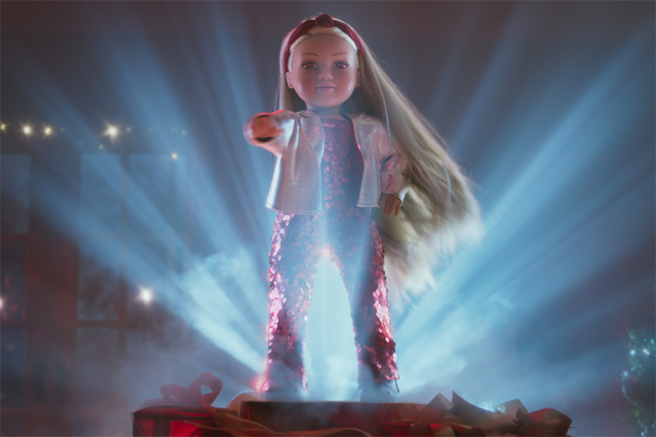 Argos Christmas ad with doll Connie front and center with a spotlight and pink jumpsuit